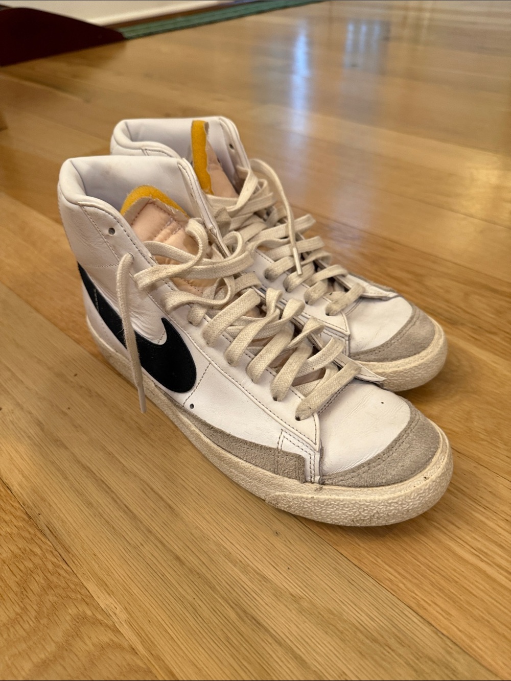 Nike Women's White High-Top Sneakers with Black Swoosh and Yellow Tongue